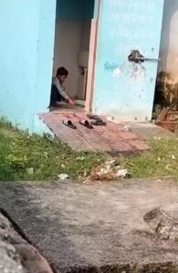 school children cleaning toilet